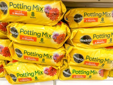 Plymouth, Minnesota - March 27, 2023: Miracle Gro brand Potting Mix for gardening and potting plants on display at a Target store clipart