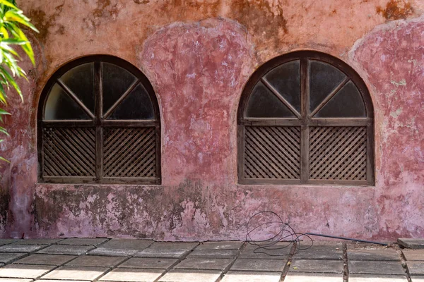 stock image Arched windows of an old building with a rustic red wall, taken on Prison Island Zanzibar Tanzania