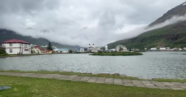アイスランドのシーディスフィヨルムール 2023年7月5日 湾を横切ってセイディスフィヨルムルの小さな漁村の景色 パニングショット — ストック動画