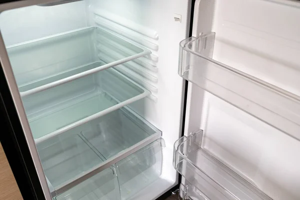 Empty white refrigerator, very clean with door open