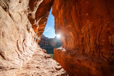 The Subway Cave with sunflare in Sedona Arizona clipart