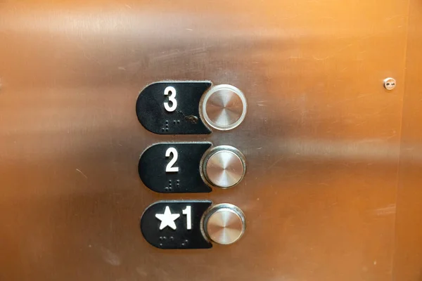 Elevator buttons inside the elevator, for floors 1, 2 and 3