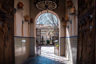 Sedona, Arizona - March 10, 2024: Doorway entrance to the galleries and shops of Tlaquepaque shopping area clipart