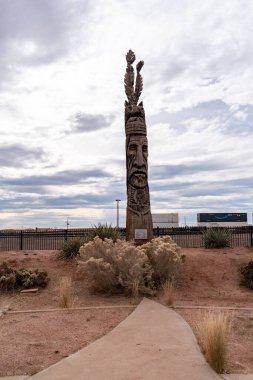 Winslow, Arizona - December 18, 2023: Peter Wolf Toth Trail of the Whispering Giants totem pole in a park clipart