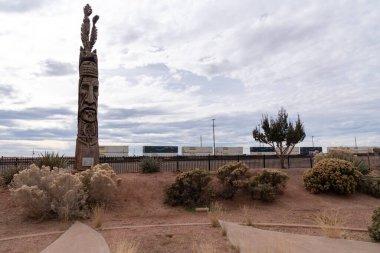 Winslow, Arizona - December 18, 2023: Peter Wolf Toth Trail of the Whispering Giants totem pole in a park clipart
