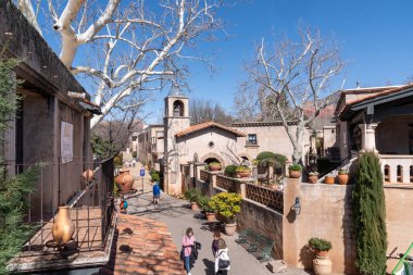 Sedona, Arizona - March 10, 2024: Shoppers browse through the galleries and shops of Tlaquepaque clipart