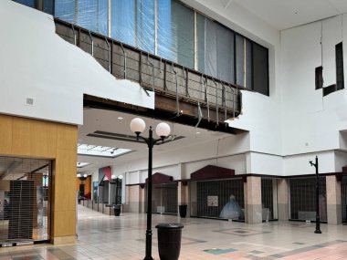 Temple, Texas - June 23, 2024: Tornado damage from inside the nearly empty Temple Mall, with closed stores and no people clipart