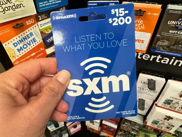 stock image Temple, Texas - June 26, 2024: Hand holds up a SiriusXM gift card for the radio service