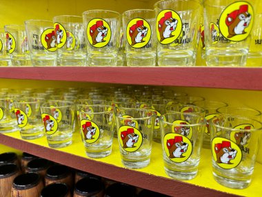 Temple, Texas - June 28, 2024: Shot glasses with the Buc-Ee beaver mascot for sale at the Buc-Ees gas station and travel center store clipart