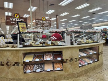 Temple, Texas - June 28, 2024: Buc-Ees grill and bakery area inside the store selling freshly made fudge and other treats clipart