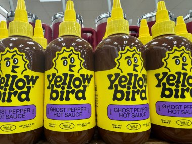 Temple, Texas - June 28, 2024: Yellow Bird brand ghost pepper hot sauce for sale clipart