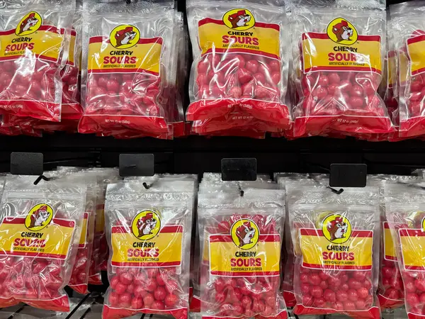 stock image Temple, Texas - June 28, 2024: Cherry sours chewy candy bags for sale at the Buc-Ees gas station and travel center store