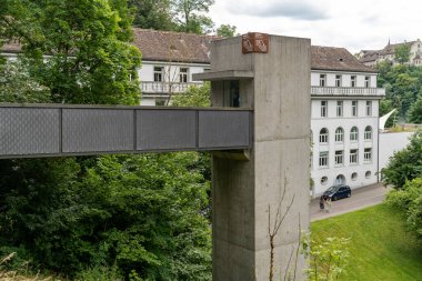 Schaffhausen Canton, Switzerland - July 17, 2024: Elevator for tourists takes people down to the viewing area of Rhine Falls (Rhinefall) clipart