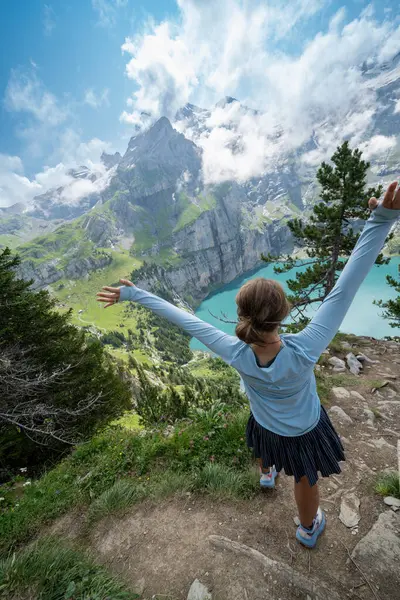 stock image Woman hiker at Oeschinensee Lake hike in Switzerland, near Kandersteg in the Swiss Alps, outstretched arms