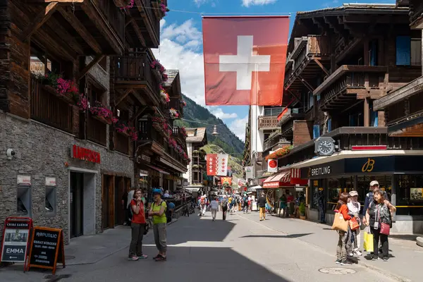 stock image Zermatt, Switzerland - July 27, 2024: Old Town Zermatt with shops, restaurants and walking paths in this car-free Swiss village. Bahnhofstrasse Main shopping street