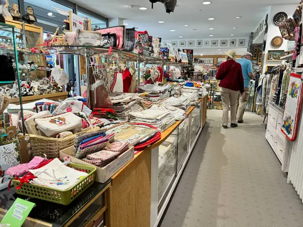 stock image Grindelwald, Switzerland - July 25, 2024: Various gifts and linens, with handmade items sale in a gift shop at Kleine Scheidegg