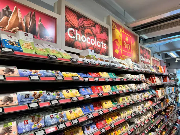 Stock image Geneva, Switzerland - July 29, 2024: Huge display of Swiss chocolates for sale in a Migros grocery store