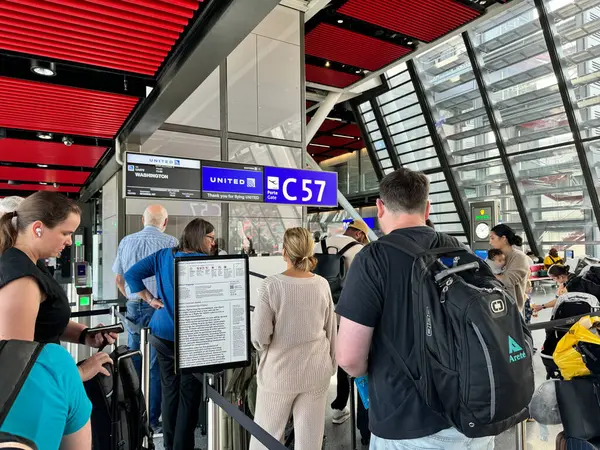 stock image Geneva, Switzerland - July 30, 2024: Passengers wait to board a United Airlines flight, waiting in line