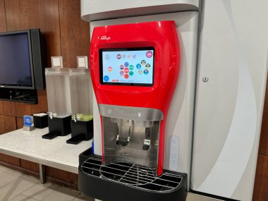 Dulles, Virginia - July 16, 2024: Coca-Cola Freestyle machine inside of the United Airlines Club Lounge at the IAD Dulles Airport clipart