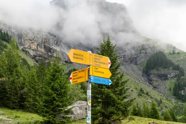 stock image Kandersteg, Switzerland - July 24, 2024: Hiking trail direction signs for visiting Oeschinensee Lake