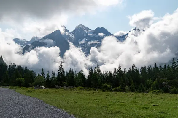 stock image Clouds surround mountains near Oeschinensee Lake hike in Switzerland, near Kandersteg in the Swiss Alps