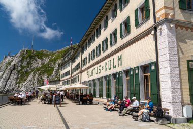 Pilatus, Switzerland - July 19, 2024: Outside the restaurant outdoor seating area at the historic Hotel Pilatus-Kulm on top of Mt. Pilatus clipart