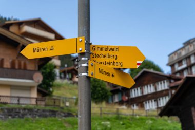 Various directional hiking signs to trails in Murren and Gimmelwald Switzerland clipart