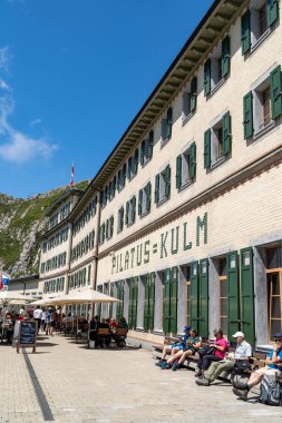 Pilatus, Switzerland - July 19, 2024: Outside the restaurant outdoor seating area at the historic Hotel Pilatus-Kulm on top of Mt. Pilatus clipart