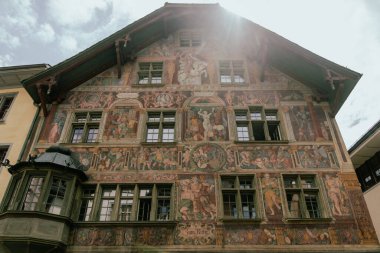 Schaffhausen, Switzerland - July 17, 2024: House of the Knight (Haus Zum Ritter) from 1492 with fresco paintings by Tobias Stimmer in old town of Schaffhausen, Switzerland clipart