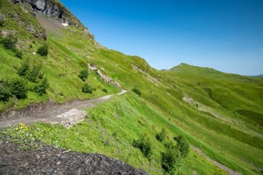 Mannlichen to Kleine Scheidegg hiking trail scenery in Switzerland on a clear summer day clipart