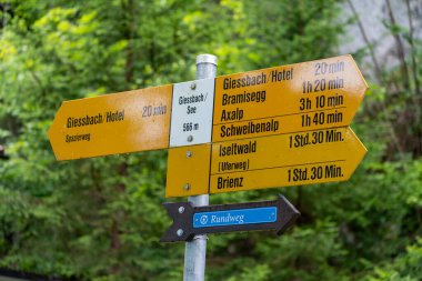 Brienz, Switzerland - July 21, 2024: Hiking trail directional signs near Giessbach falls and hotels, on Lake Brienz. Switzerland clipart