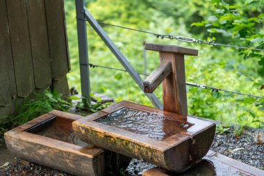 Drinking fountain trough with fresh, clean potable drinknig water - Switzerland clipart