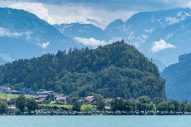 Small village of Brienz in Switzerland, on Lake Brienz, mountains in background clipart