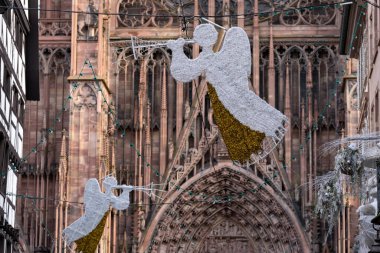 Angel Christmas decorations in front of the cathedral dome in Strasbourg France clipart