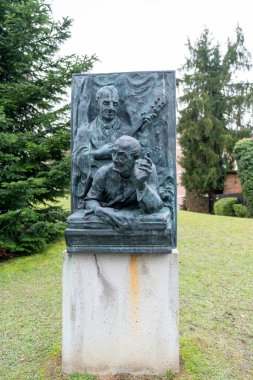 Oberndorf bei, Austria - November 29, 2024: Statue honoring the musician and composer of Silent Night Christmas song at the Silent Night chapel near Salzburg, Austria clipart