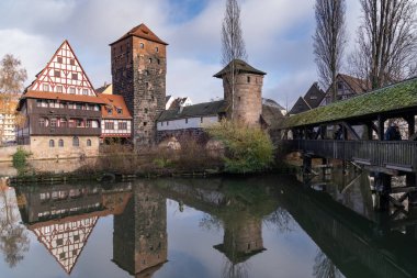 View from the famous Maxbrucke bridge in this historic old town of Nuremberg Germany, Bavaria, with reflection, taken in winter clipart