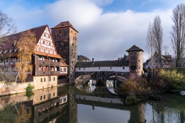 View from the famous Maxbrucke bridge in this historic old town of Nuremberg Germany, Bavaria, with reflection, taken in winter clipart