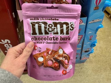 Fairfax, Virginia - 1 Şubat 2025: El, M & M şekerlerinden oluşan Sevgililer Günü temalı bir paket tutuyor