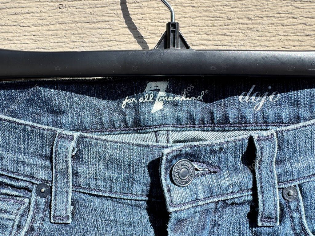New Hope, Minnesota - April 5, 2025: Close up logo of a Seven for All Mankin premium designer denim jeans back pocket