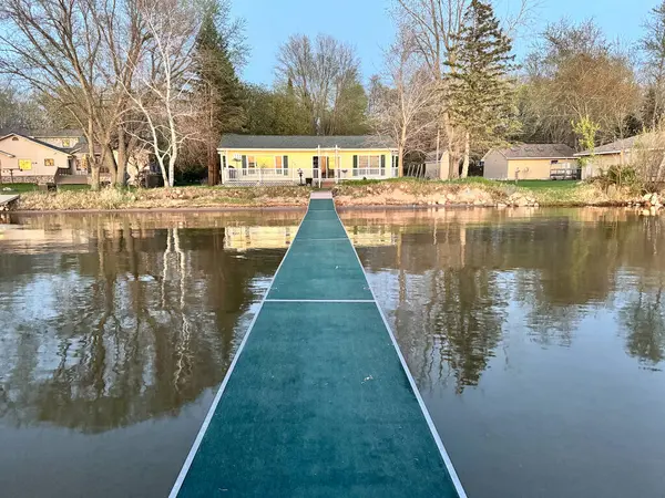 Baharın başlarında Scandia Minnesota 'daki Büyük Deniz Gölü' nde rıhtımda çekilmiş bir fotoğrafla Lakeshore 'da bir ev.