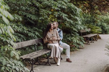 Mutlu ve sevgi dolu bir çift parkta eğleniyor. Sevgili çift birlikte vakit geçiriyor. Dövmeli kız. Dövmeli kadın. Sokakta güzel, modaya uygun bir çift sevgili. Çift.