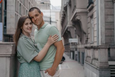 Kasabayı gezerken kucaklaşan mutlu iki turist. Polonya, Varşova 'daki kültür ve bilim sarayının önünde mutlu bir çift. Öpüşen bir çifti yakından çek..