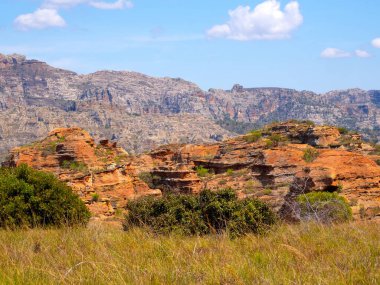 Weathered colorful rocks overgrown with vegetation in N.P Isalo. Madagascar.