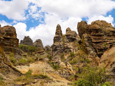 Pyramids of weathered colored rock overgrown with vegetation in N.P Isalo. Madagascar.