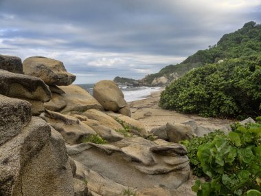 Graceful boulders on the coast in Tayrona National Park. Colombi clipart