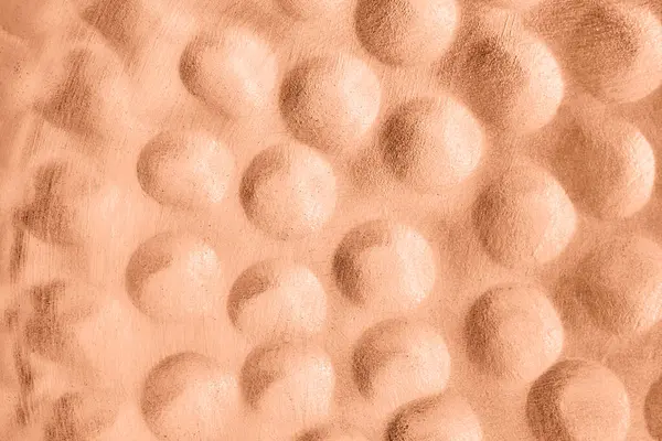 Abstract background, metallic peach fuzz color. Volumetric bubbles pattern. Futuristic style.
