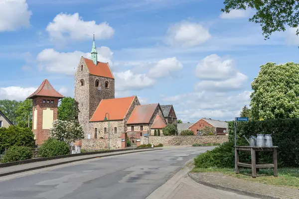 stock image Village street in Gro Schwechten with Romanesque village church made of field stones, Saxony-Anhalt, Germany