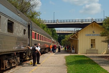 Akron, OH, USA - September 15, 2022: Passengers and crew on a Cuyahoga Valley Scenic Railroad train relax during a stop at Akron Northside Station, the southern end point for the popular line.