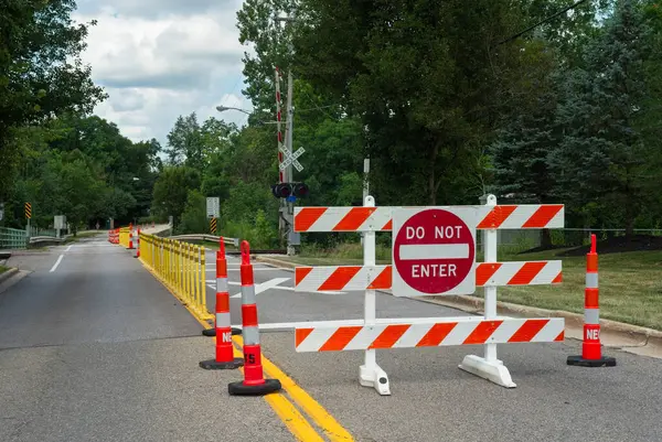 stock image A road closure sign alerting drivers to construction ahead that closes half of the road