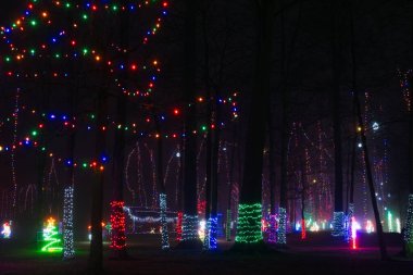 An outdoor Christmas tableau of festive lights and decoration in a city park in northeast Ohio clipart